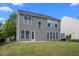 Exterior view of the backyard with a concrete patio and grassy area at 209 Oswego Ct, Morrisville, NC 27560