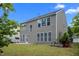 Exterior view of the backyard with a concrete patio and green grass at 209 Oswego Ct, Morrisville, NC 27560