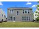 Exterior view of the backyard with a concrete patio and green grass at 209 Oswego Ct, Morrisville, NC 27560