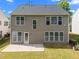 View of the backyard with a concrete patio and green grass at 209 Oswego Ct, Morrisville, NC 27560