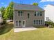 The home's rear exterior features a well-manicured lawn and multiple windows for bright, natural light at 209 Oswego Ct, Morrisville, NC 27560