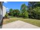 Spacious backyard offering lush greenery, mature trees, and a concrete patio at 209 Oswego Ct, Morrisville, NC 27560