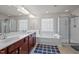 Well-lit bathroom featuring double sinks, soaking tub and walk-in shower at 209 Oswego Ct, Morrisville, NC 27560
