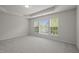 Bedroom with tray ceiling and large windows overlooking the backyard at 209 Oswego Ct, Morrisville, NC 27560