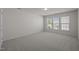 Neutral bedroom with carpet, white walls, three windows and natural light at 209 Oswego Ct, Morrisville, NC 27560