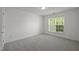 Bright bedroom with carpet, white walls, a window with blinds and natural light at 209 Oswego Ct, Morrisville, NC 27560