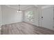 Dining room featuring decorative molding, trey ceiling, wood laminate flooring, and natural light at 209 Oswego Ct, Morrisville, NC 27560