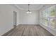 Dining room featuring decorative molding, trey ceiling and wood laminate flooring at 209 Oswego Ct, Morrisville, NC 27560