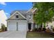 Charming two-story home with a two-car garage and a well-kept lawn at 209 Oswego Ct, Morrisville, NC 27560