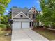 Charming two-story home with a well-manicured lawn, two-car garage, and brick and siding exterior at 209 Oswego Ct, Morrisville, NC 27560