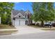Beautiful two-story home with a two-car garage, a well-maintained lawn, and mature shade trees at 209 Oswego Ct, Morrisville, NC 27560