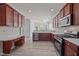 Kitchen with stainless steel appliances, dark wood cabinets, wood laminate flooring and natural light at 209 Oswego Ct, Morrisville, NC 27560
