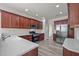 Open kitchen with stainless steel appliances, dark wood cabinets and wood laminate floors at 209 Oswego Ct, Morrisville, NC 27560