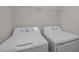 Bright laundry room featuring a GE washer and dryer, and a wire storage shelf at 209 Oswego Ct, Morrisville, NC 27560