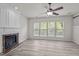 Bright living room featuring a fireplace, hardwood floors, and large windows at 209 Oswego Ct, Morrisville, NC 27560