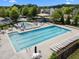 Community pool featuring ample seating, a splash pool, and a covered playground for residents' enjoyment at 209 Oswego Ct, Morrisville, NC 27560