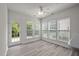 Bright sunroom with multiple windows overlooking the backyard and a glass door for outside access at 209 Oswego Ct, Morrisville, NC 27560