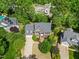 Birds eye view of the property featuring a well-maintained house, lush greenery, and surrounding mature trees at 210 Highlands Lake Dr, Cary, NC 27518