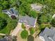 A well-maintained brick home with an attached garage, lush landscaping, and a private backyard at 210 Highlands Lake Dr, Cary, NC 27518