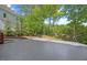 A view of the home's stamped concrete patio, surrounded by landscaping and trees, creating a private outdoor space at 210 Highlands Lake Dr, Cary, NC 27518