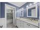 Bathroom featuring dual sinks, granite countertops, and tiled shower, showcasing a stylish and functional design at 210 Highlands Lake Dr, Cary, NC 27518