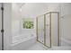 Elegant bathroom featuring a tub, shower, and large window providing natural light at 210 Highlands Lake Dr, Cary, NC 27518