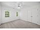 This bedroom features neutral paint, carpet, and ample natural light, with plenty of room to relax at 210 Highlands Lake Dr, Cary, NC 27518
