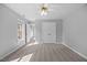Bright bedroom with carpet, ceiling fan, windows and a closet with white double doors at 210 Highlands Lake Dr, Cary, NC 27518