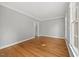 Bright and airy bedroom featuring hardwood floors and a large window at 210 Highlands Lake Dr, Cary, NC 27518