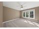 Inviting bedroom features neutral paint, carpet, and ample natural light, creating a flexible and inviting space at 210 Highlands Lake Dr, Cary, NC 27518