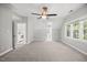 Large bonus room with neutral paint, carpet, and ample natural light, with attached laundry and room to relax at 210 Highlands Lake Dr, Cary, NC 27518