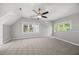 Upstairs bonus room features neutral paint, carpet, and ample natural light, creating a flexible and inviting space at 210 Highlands Lake Dr, Cary, NC 27518