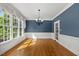 Bright dining room with hardwood floors, large windows, and elegant chandelier at 210 Highlands Lake Dr, Cary, NC 27518