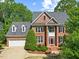 Lovely brick home with well-kept landscaping, attached garage, and a welcoming facade at 210 Highlands Lake Dr, Cary, NC 27518