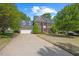 A brick home on a large lot with an attached garage and classic architectural design at 210 Highlands Lake Dr, Cary, NC 27518