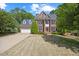 Traditional brick home features a well manicured lawn, dormer windows and attached two car garage at 210 Highlands Lake Dr, Cary, NC 27518