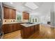 Bright kitchen with granite counters, wooden cabinets, and center island at 210 Highlands Lake Dr, Cary, NC 27518