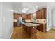 Spacious kitchen featuring granite countertops, wooden cabinets, and stainless appliances at 210 Highlands Lake Dr, Cary, NC 27518
