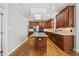 Modern kitchen featuring granite countertops, wood cabinets, and stainless appliances at 210 Highlands Lake Dr, Cary, NC 27518