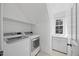 A bright laundry room offers convenience with a sink, cabinets, and plenty of counter space for folding at 210 Highlands Lake Dr, Cary, NC 27518