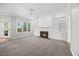 Bright living room features a fireplace, built-in shelving, and large windows that let in ample natural light at 210 Highlands Lake Dr, Cary, NC 27518