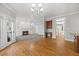 Open-concept living room with fireplace, built-ins, and hardwood floors at 210 Highlands Lake Dr, Cary, NC 27518