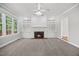 Spacious living room features a brick fireplace and built-in shelving, perfect for entertaining or cozy nights at 210 Highlands Lake Dr, Cary, NC 27518