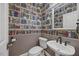 The powder room has distinctive library wallpaper with pedestal sink at 210 Highlands Lake Dr, Cary, NC 27518