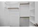 Spacious walk-in closet with wood rods and shelving, providing ample storage space at 210 Highlands Lake Dr, Cary, NC 27518