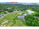 Aerial view of community golf course and nearby Jordan Lake featuring lush greenery and waterscapes at 213 North Crest Dr, Chapel Hill, NC 27517