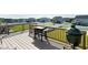 Back deck with grill overlooking backyard with white fence and neighborhood homes in the distance at 213 North Crest Dr, Chapel Hill, NC 27517