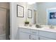 Bathroom with a double sink vanity and framed artwork and neutral colored towels at 213 North Crest Dr, Chapel Hill, NC 27517