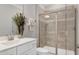 Bathroom featuring a glass shower, modern fixtures, white cabinets and a neutral tile backsplash at 213 North Crest Dr, Chapel Hill, NC 27517