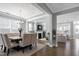 Open concept dining room with hardwood flooring, decorative lighting and seamless access to the living room at 213 North Crest Dr, Chapel Hill, NC 27517